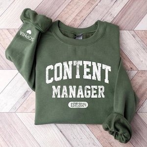 May include A green sweatshirt with the text CONTE