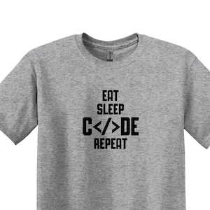 May include A heather grey t shirt with the text E