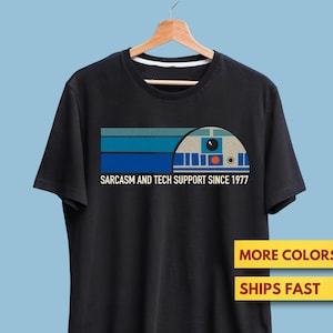 May include Black t shirt with a graphic of a robo