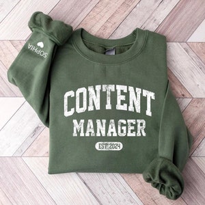 May include A green sweatshirt with the text CONTE
