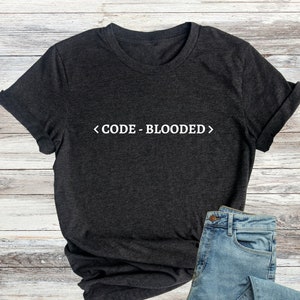 May include A dark gray t shirt with the text CODE