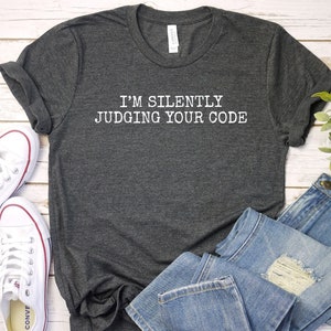 May include A dark gray t shirt with the text Im s