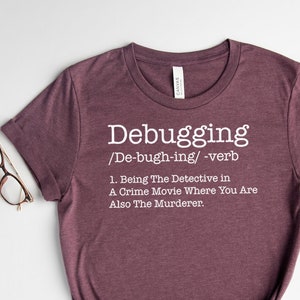 May include A heather maroon t shirt with the text